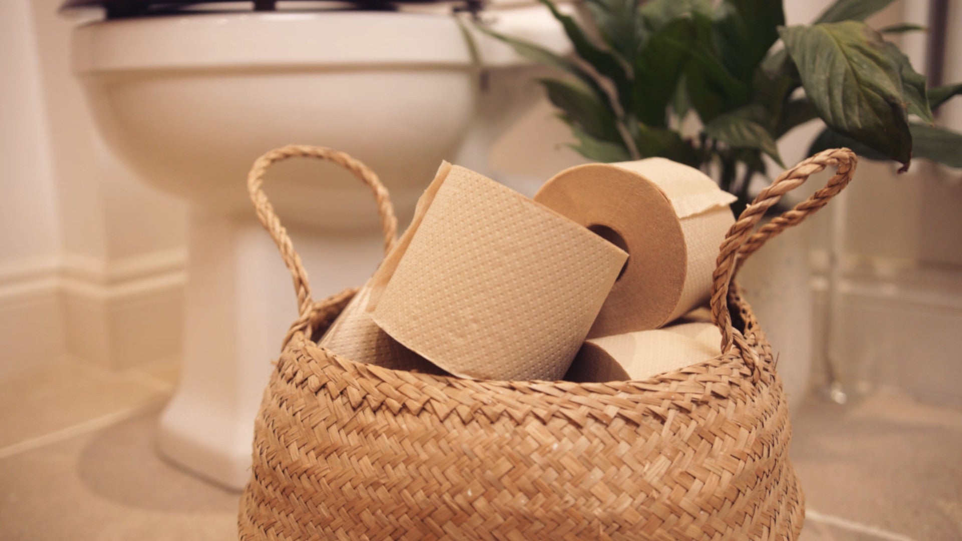 A basket of rolls of unbleached toilet paper